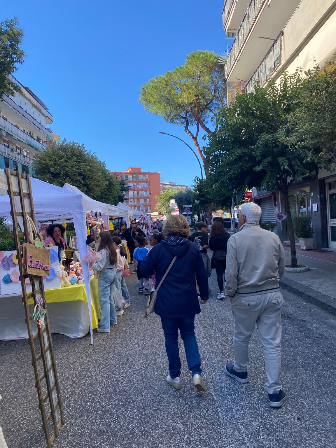 Persone che visitano i banchi di un’iniziativa all’aperto